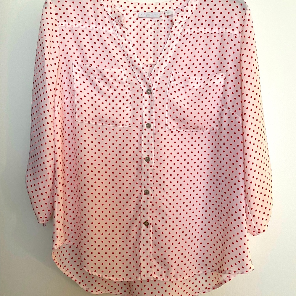 A white with red poke a dotted blouse.
